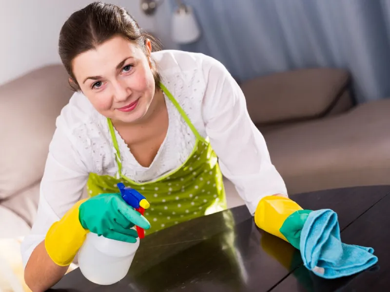 Support worker folding laundry as part of NDIS cleaning support