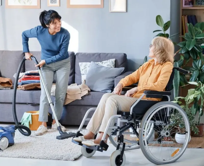 Support worker mopping the floor in a participant's home during an NDIS cleaning visit
