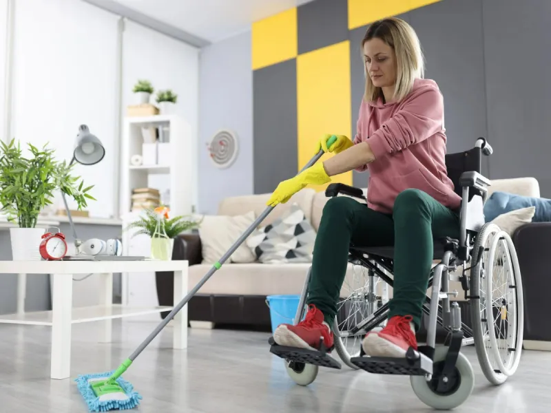 Support worker wiping down bathroom surfaces during a cleaning visit