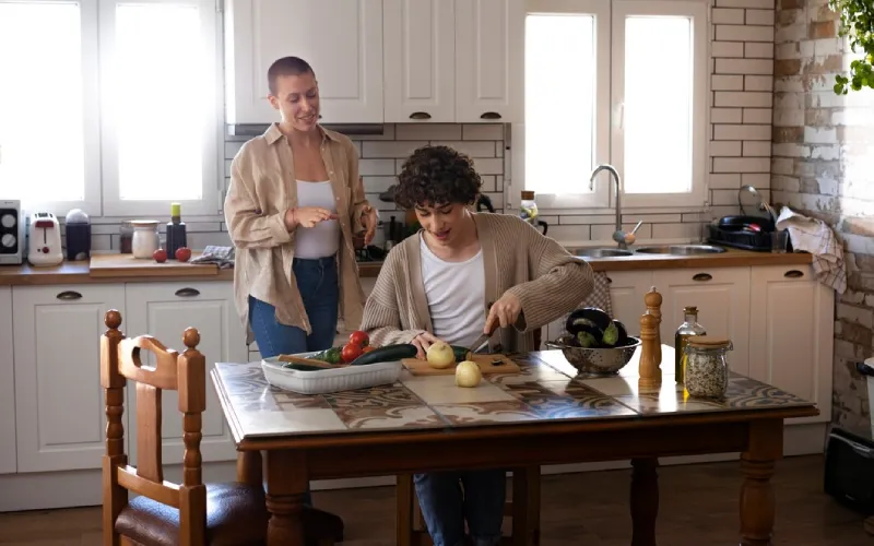 Support worker helping a participant with household chores at home