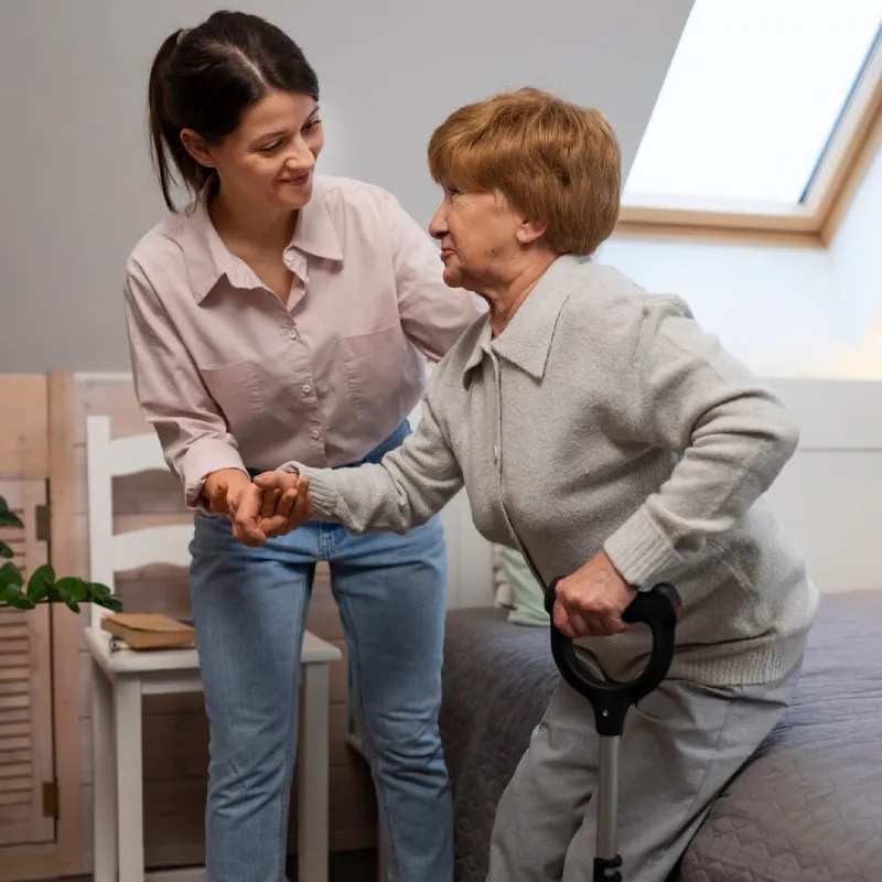 Support worker vacuuming a participant's living room floor