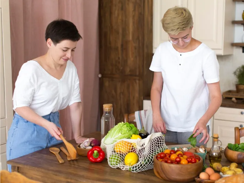 Support worker helping a participant prepare a meal in the kitchen