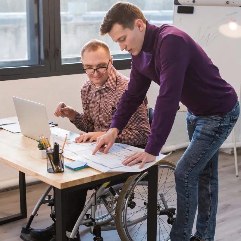 Support worker guiding a participant through a daily living skill