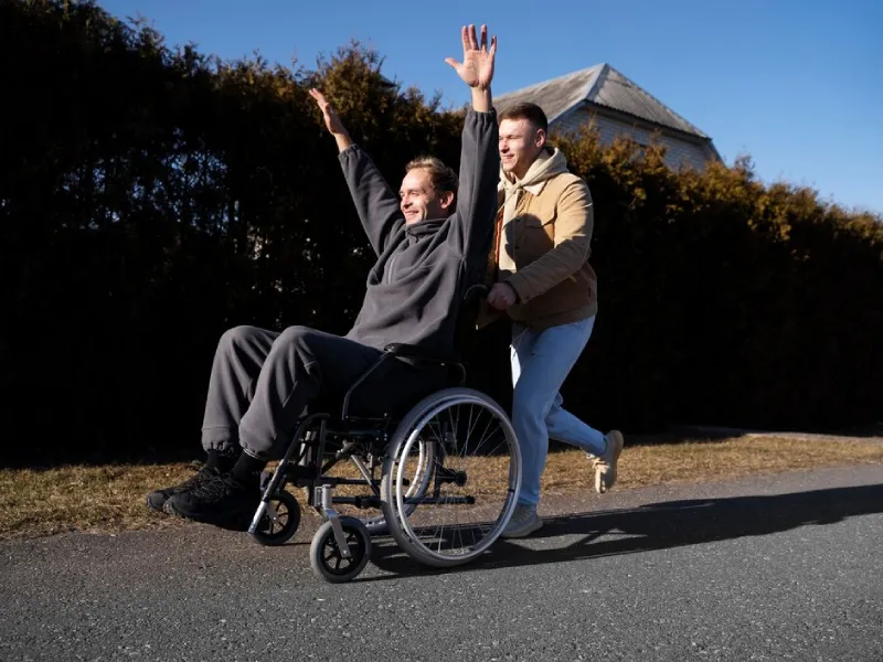 Support worker walking alongside a participant during a community outing