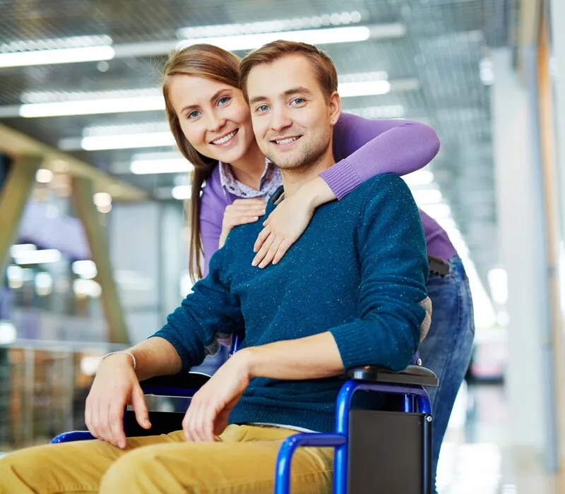 Support worker helping a participant into a car for a trip