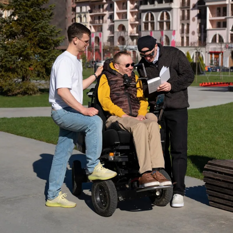 Support worker assisting a participant with a mobility aid while travelling