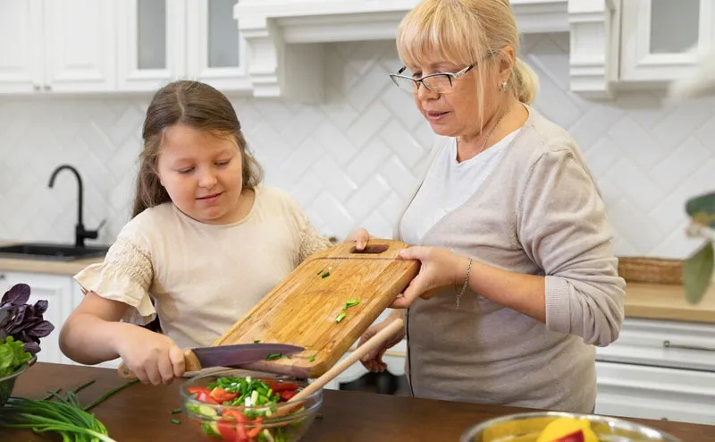 Support worker helping a participant prepare a meal in their kitchen